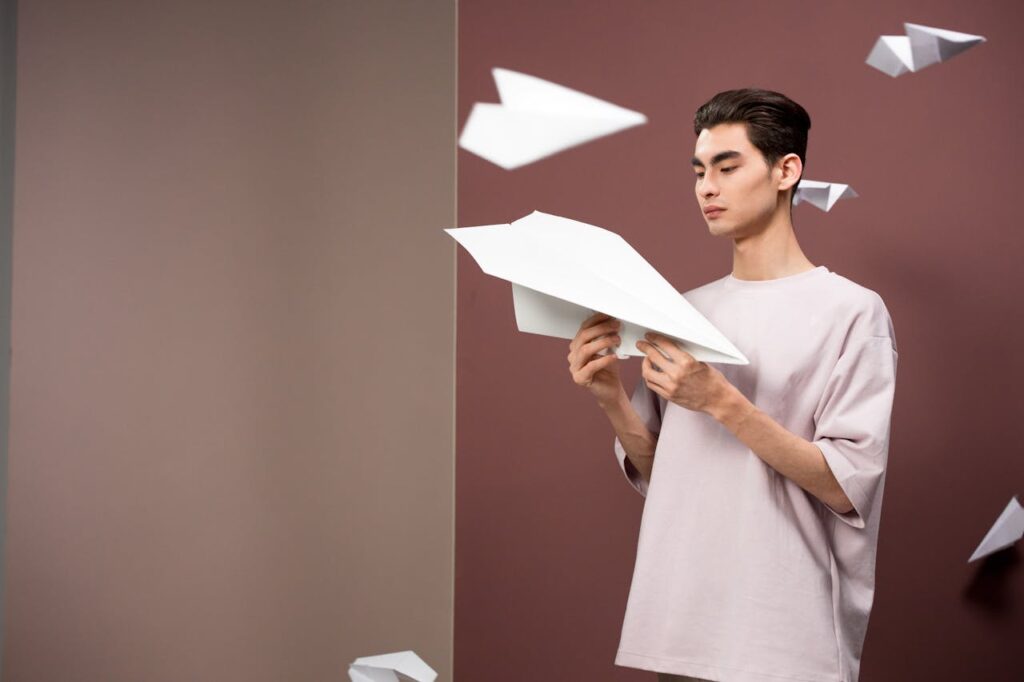 Paper Planes Flying around Man